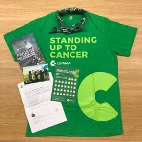 Photo of the content of Canteen's Welcome pack. The pack contains a green t-shirt which has the words 'Standing up to Cancer' on the front. There is a green bandana and a number of paper assets including a thank you card and daily tracker.