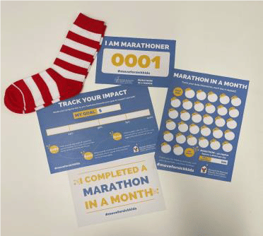 Photo of RHMC Greater Western Sydney's Facebook Challenge welcome pack. The pack contains a pair of striped socks, in the photo they are red and white. It also contains a daily tracker, a Marathon running number slip and a card that reads 'I completed Marathon in a Month'