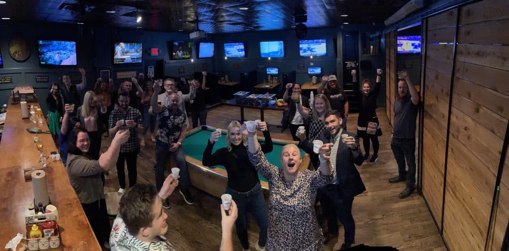 Photo of the GivePanel social event as part of the Peer-to-Peer Professional Forum. People in a bar with drinks 
